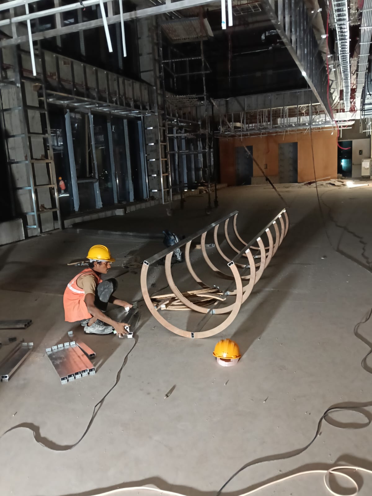 Curved metal ribs being assembled for a round pillar covering